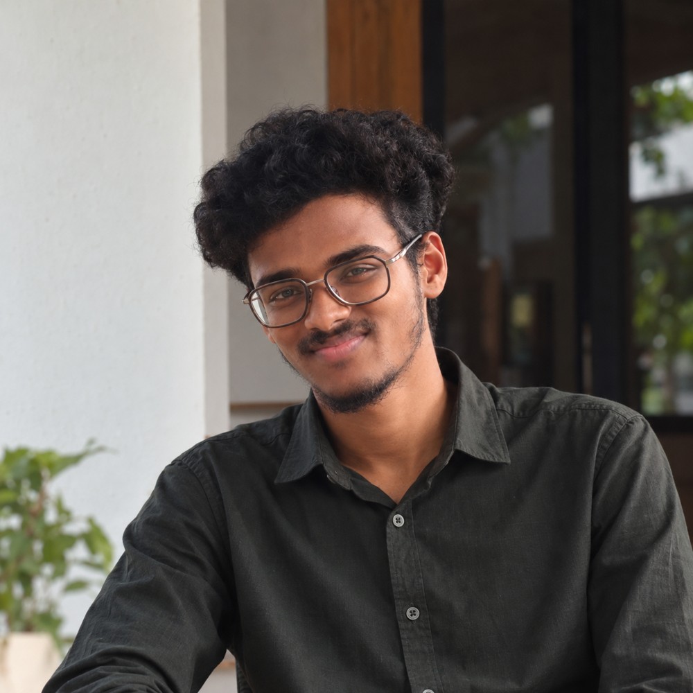 Abhiraj wearing glasses and a dark shirt